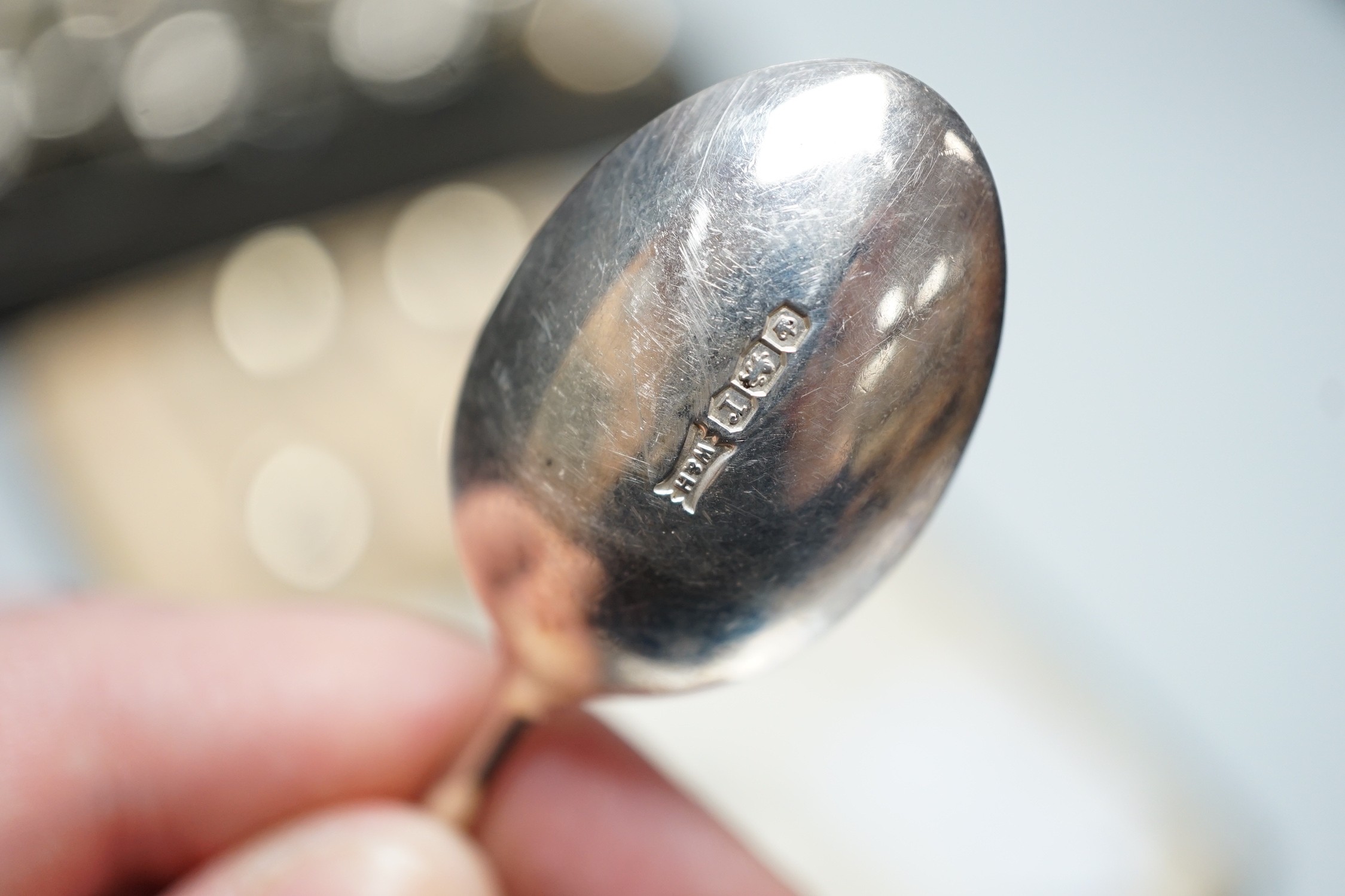 A cased George V ten piece silver condiment set, with four (ex 6) spoons, maker, RR, Birmingham, 1936 and London, 1929, together with a cased set of six silver teaspoons.